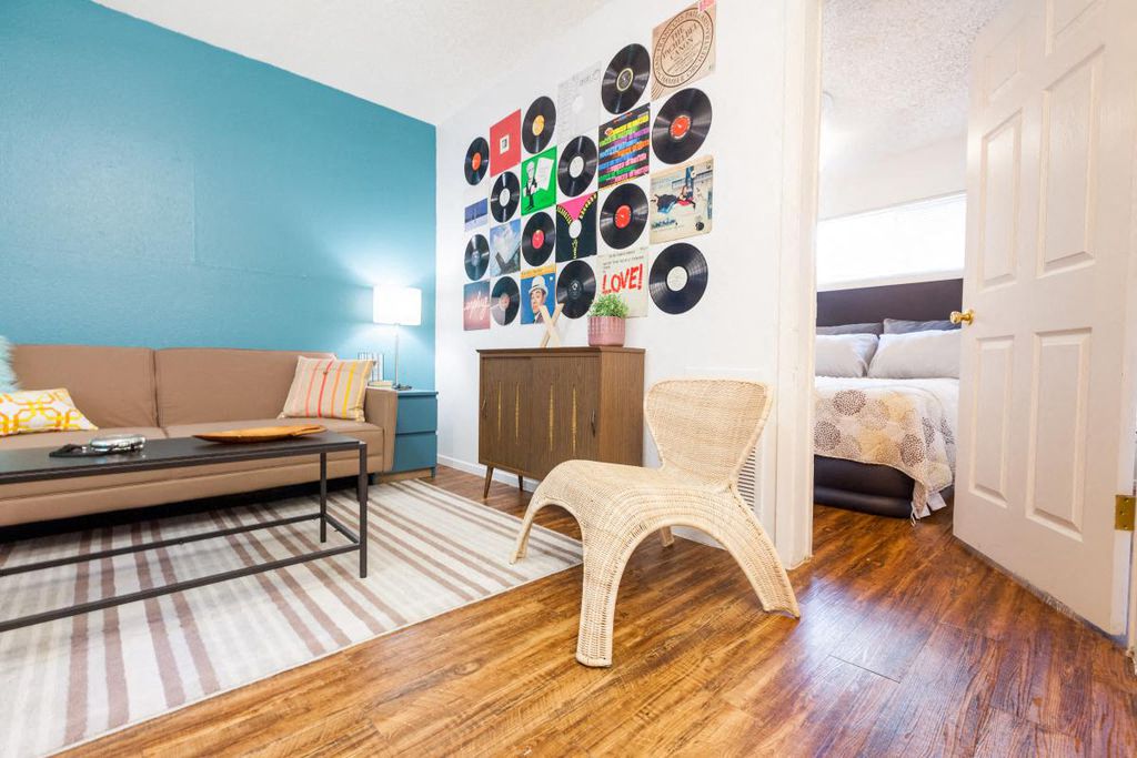 a living room with a couch and a wall of records